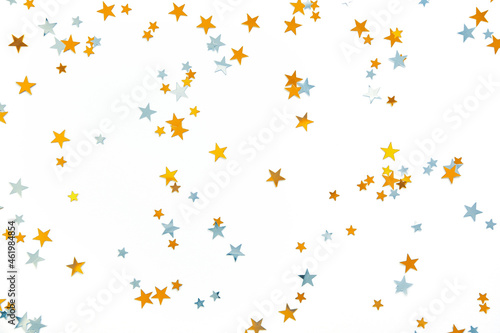 Gold and silver stars  holiday confetti on a white background