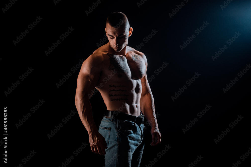 Healthy muscular young man on a dark background Healthy muscular young man on a dark background
