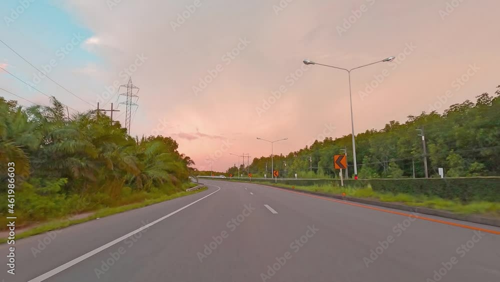 Car pov of pastel blue sky over rain-forest road street Car pov of pastel blue sky over rain-forest road street