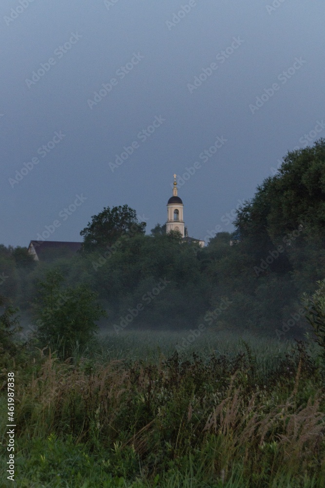 foggy landscape with a church  before sunrise in Bogolyubovo, Russia