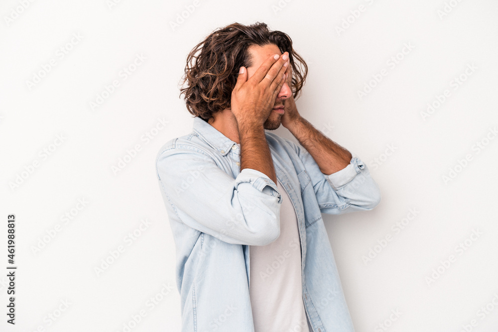 Young caucasian man isolated on white background afraid covering eyes with hands. Young caucasian man isolated on white background afraid covering eyes with hands.