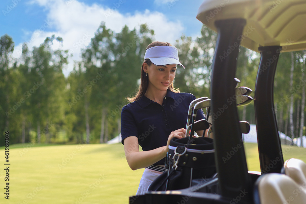 Professional woman golf player choosing the golf club from the bag. Professional woman golf player choosing the golf club from the bag.