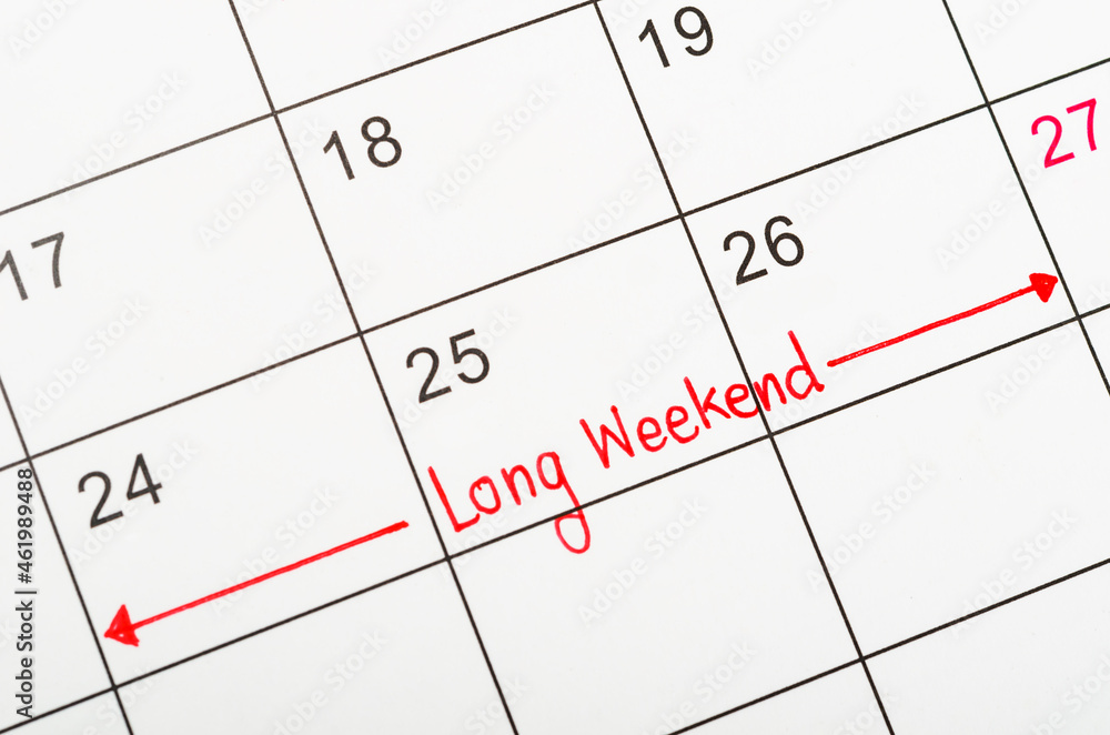 Long weekend written on a calendar to remind you and important appointment. Long weekend written on a calendar to remind you and important appointment.