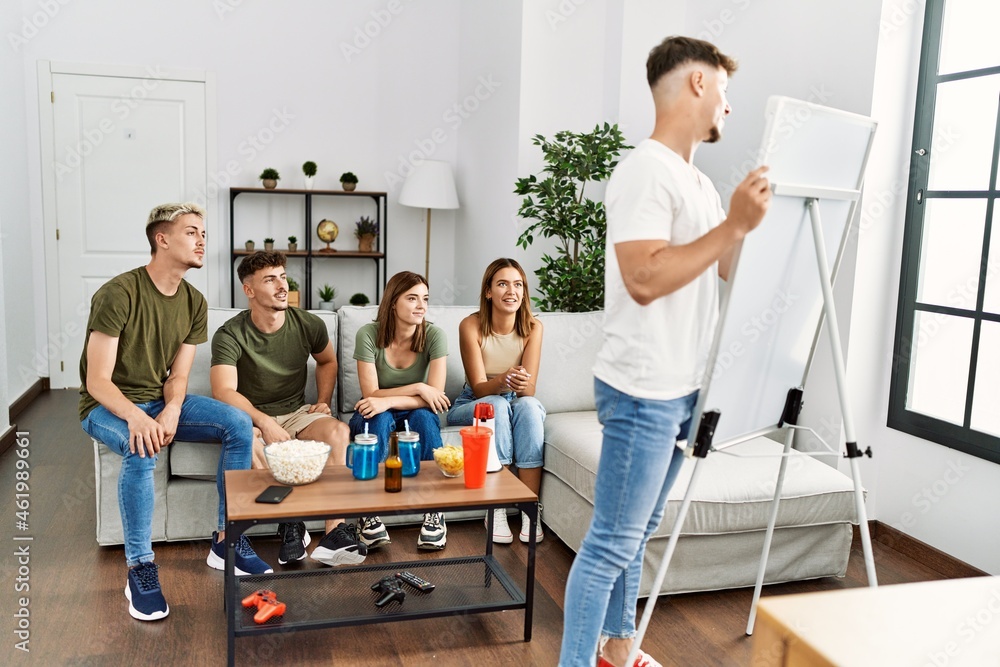 Group of young friends smiling happy playing game at home. Group of young friends smiling happy playing game at home.