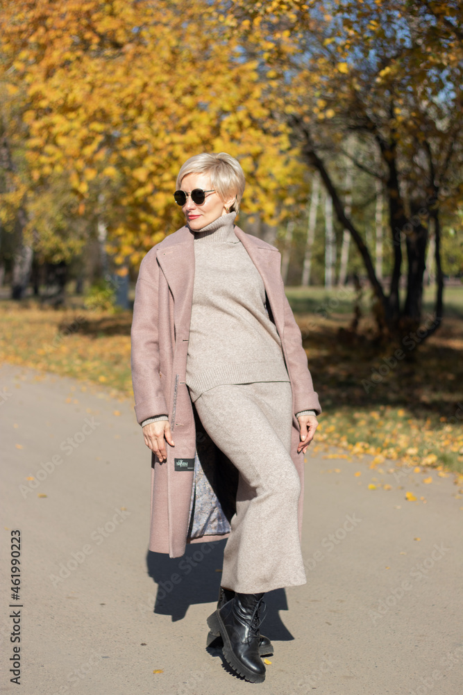 beautiful woman walks in the park in autumn beautiful woman walks in the park in autumn