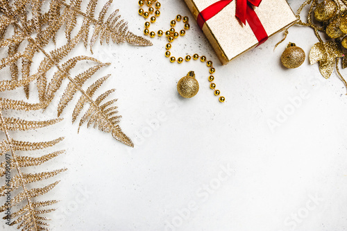 Christmas holidays composition with gold decorations on white background with copy space for your text photo