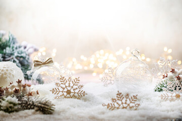Christmas white decorations on snow with fir tree branches and christmas lights. Winter Decoration Background