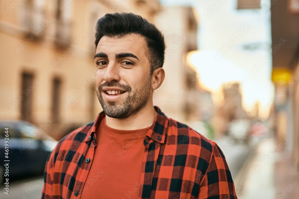 Young hispanic man smiling happy standing at the city. Young hispanic man smiling happy standing at the city.