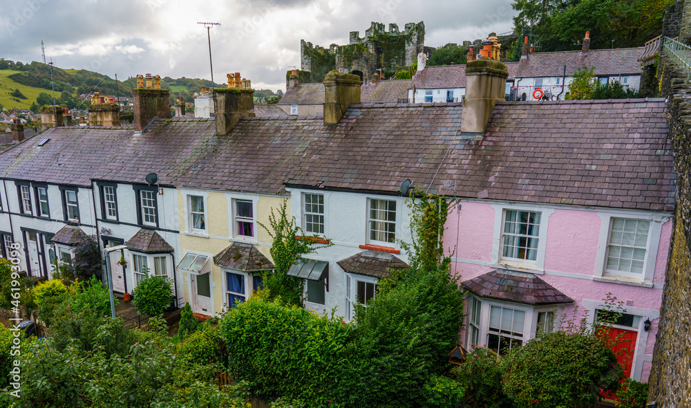 a row of colured cottages seen from the Conwy 13th century town stone wall