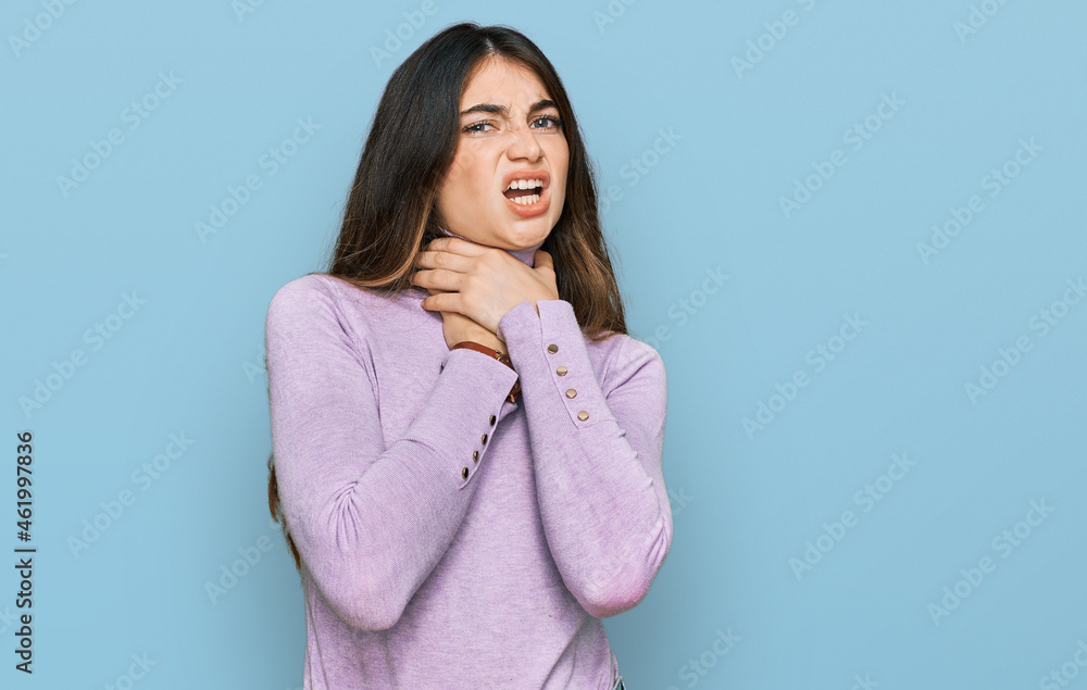 Young beautiful teen girl wearing turtleneck sweater shouting suffocate because painful strangle. health problem. asphyxiate and suicide concept. Young beautiful teen girl wearing turtleneck sweater shouting suffocate because painful strangle. health problem. asphyxiate and suicide concept.