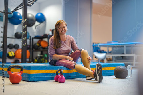 Young woman with prosthetic legs exercising at physiotherapy center
 photo