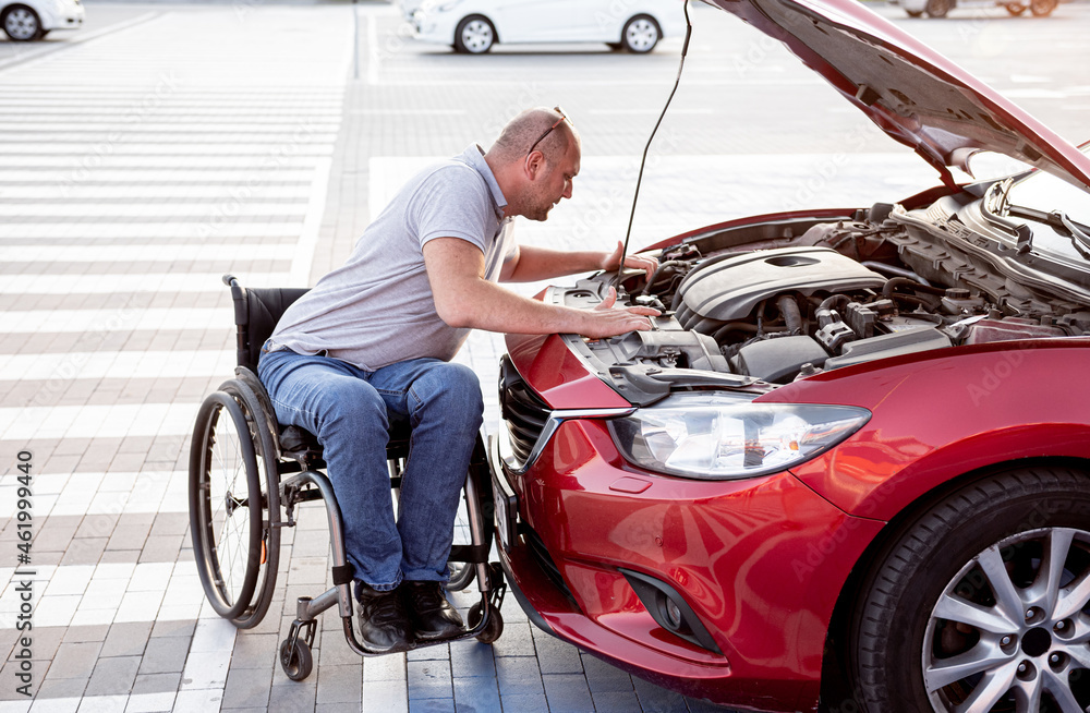 person with a physical disability check engine his car at parking