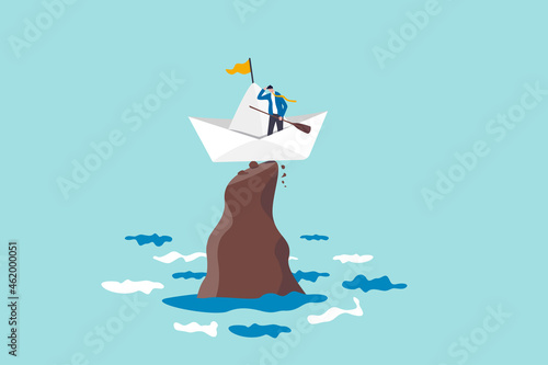 Life or business stuck, struggle with problem or obstacle, error, mistake or failure cause hopeless situation, business difficulty concept, hopeless businessman stuck on shipwrecked on high rock cliff photo