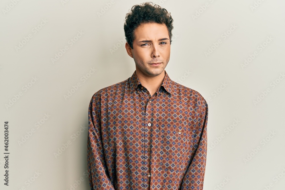 Handsome hispanic man wearing casual clothes skeptic and nervous, frowning upset because of problem. negative person. Handsome hispanic man wearing casual clothes skeptic and nervous, frowning upset because of problem. negative person.