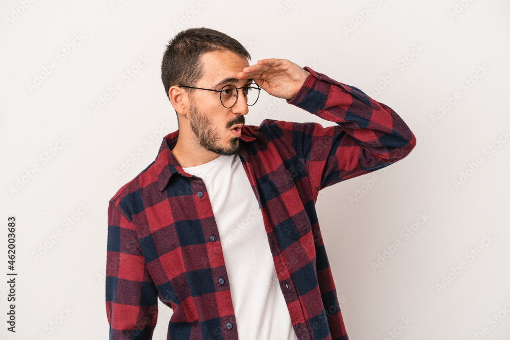 Young caucasian man isolated on white background looking far away keeping hand on forehead. Young caucasian man isolated on white background looking far away keeping hand on forehead.