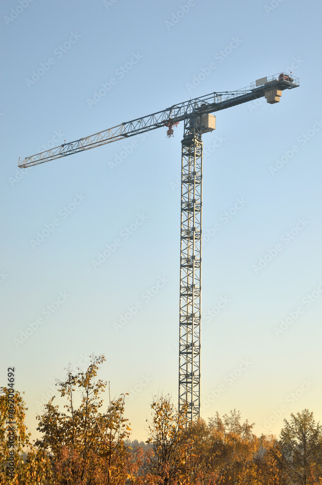 Construction crane tower against a blue sky, one object Construction crane tower against a blue sky, one object