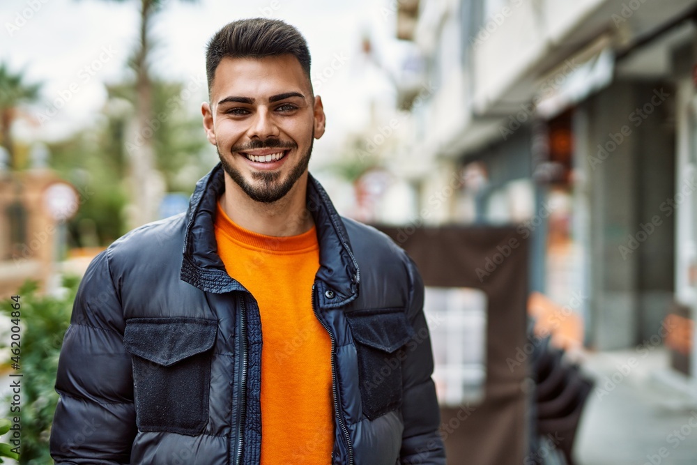 Handsome hispanic man with beard smiling happy and confident at the city wearing winter coat Handsome hispanic man with beard smiling happy and confident at the city wearing winter coat