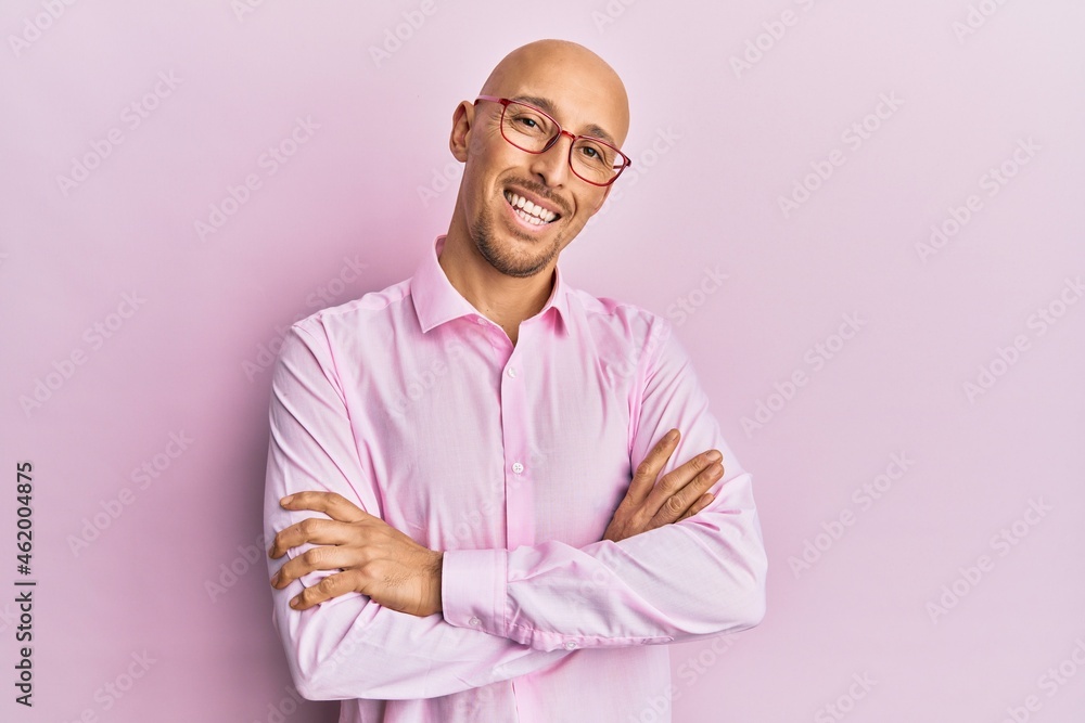 Bald man with beard wearing casual clothes and glasses happy face smiling with crossed arms looking at the camera. positive person. Bald man with beard wearing casual clothes and glasses happy face smiling with crossed arms looking at the camera. positive person.