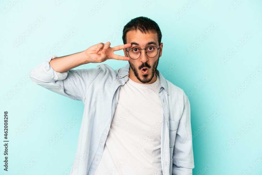 Young caucasian man isolated on blue background dancing and having fun. Young caucasian man isolated on blue background dancing and having fun.