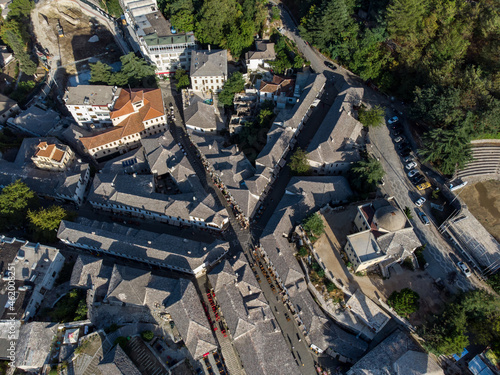Aerial drone view of old quarters of Gjirokastër, Albania. Traditional houses in the old city of Gjirokaster. UNESCO World Heritage Site. Historical buildings, architecture and cultural heritage.  