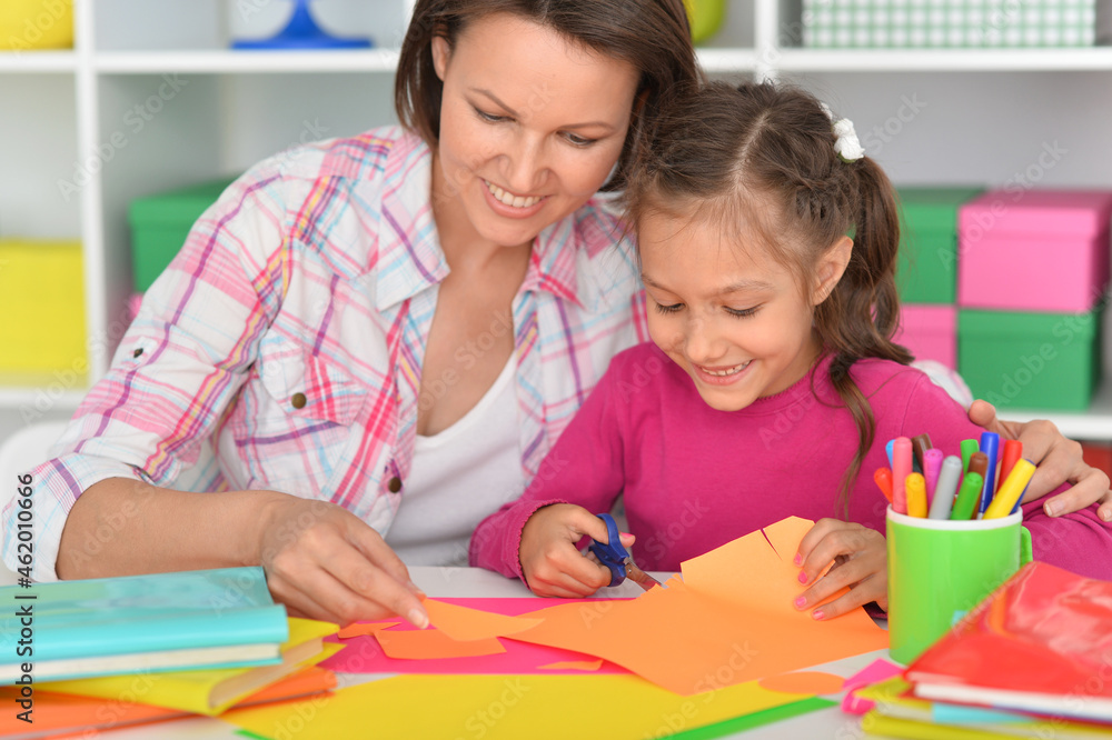 Mother teaches her cute daughter to do craft items Mother teaches her cute daughter to do craft items