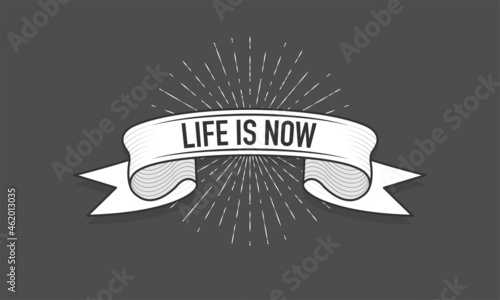 Ribbon with the inscription Life is Now. Old vintage ribbon banner in engraving style and light rays on the black background. Hand drawing. Vector illustration.