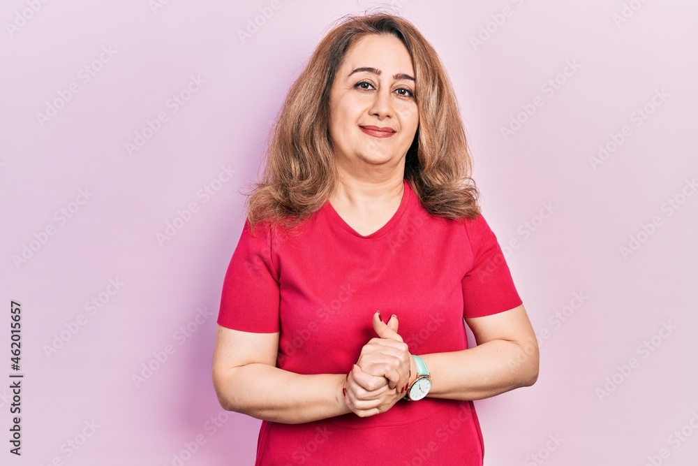 Middle age caucasian woman wearing casual clothes with hands together and crossed fingers smiling relaxed and cheerful. success and optimistic Middle age caucasian woman wearing casual clothes with hands together and crossed fingers smiling relaxed and cheerful. success and optimistic