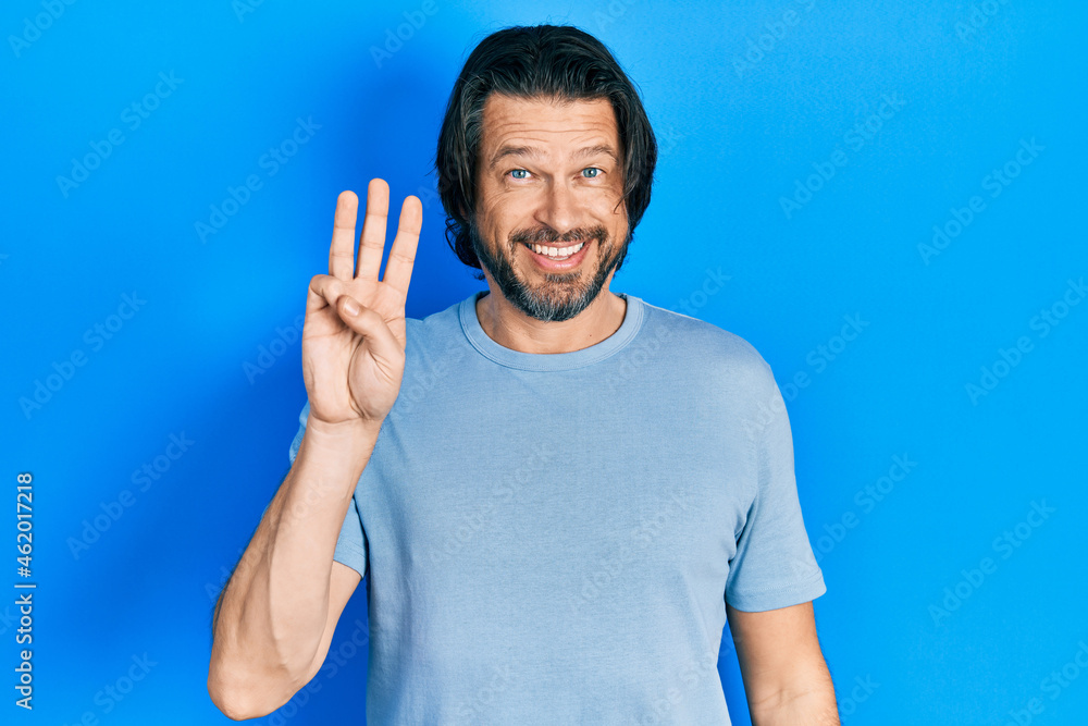 Middle age caucasian man wearing casual clothes showing and pointing up with fingers number three while smiling confident and happy. Middle age caucasian man wearing casual clothes showing and pointing up with fingers number three while smiling confident and happy.