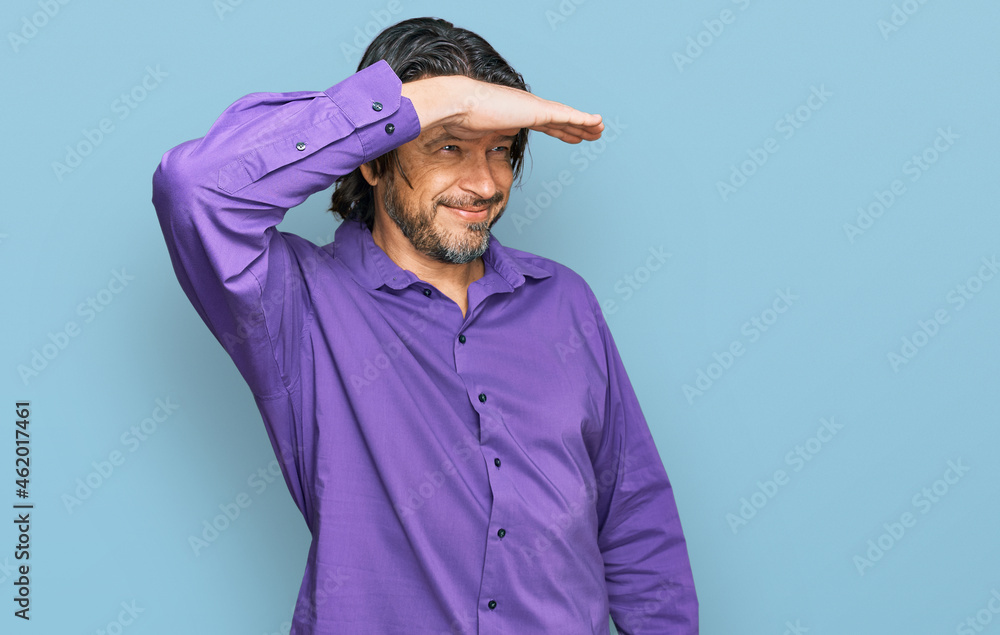 Middle age handsome man wearing business shirt very happy and smiling looking far away with hand over head. searching concept. Middle age handsome man wearing business shirt very happy and smiling looking far away with hand over head. searching concept.