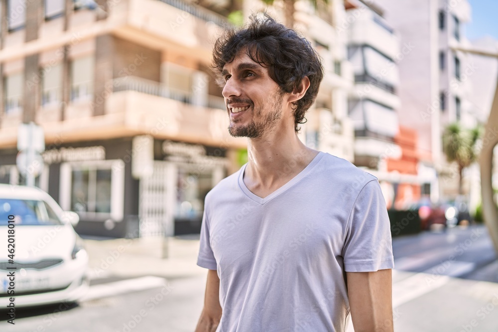 Young hispanic man smiling happy standing at the city. Young hispanic man smiling happy standing at the city.