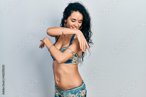 Young indian woman wearing traditional belly dancer costume. Dancing exotic oriental dance with body and hands © Krakenimages.com
