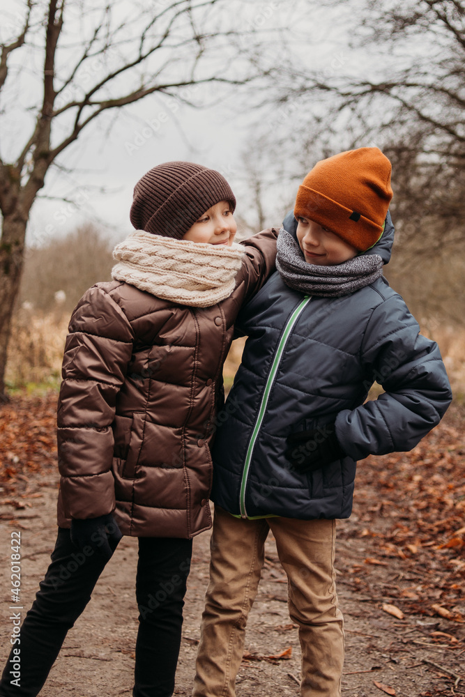 Lifestyle portrait boy and girl in autumn park Lifestyle portrait boy and girl in autumn park