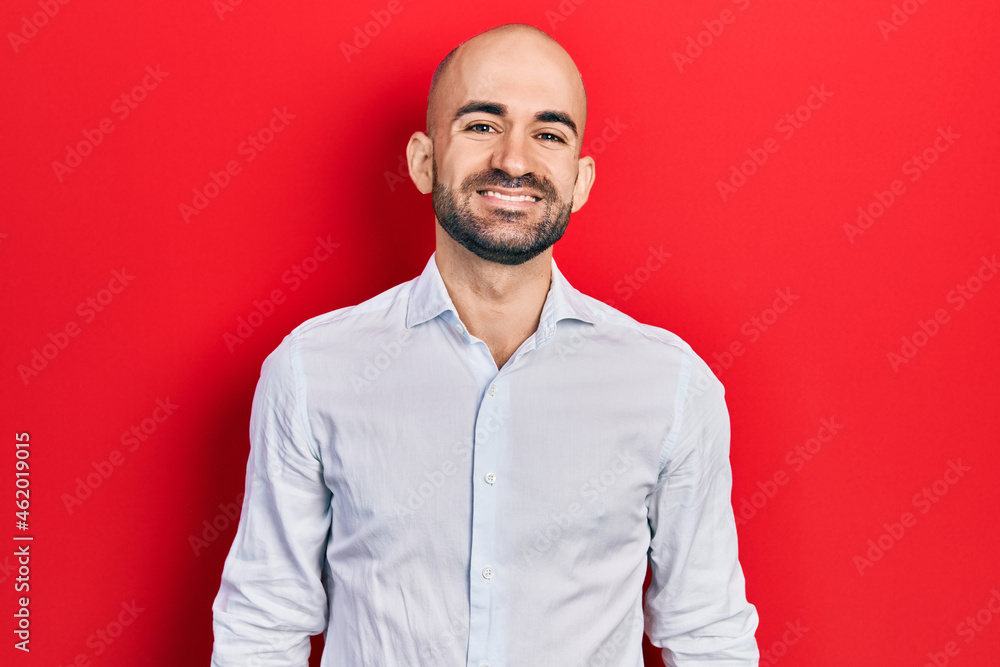 Young bald man wearing elegant clothes with a happy and cool smile on face. lucky person. Young bald man wearing elegant clothes with a happy and cool smile on face. lucky person.
