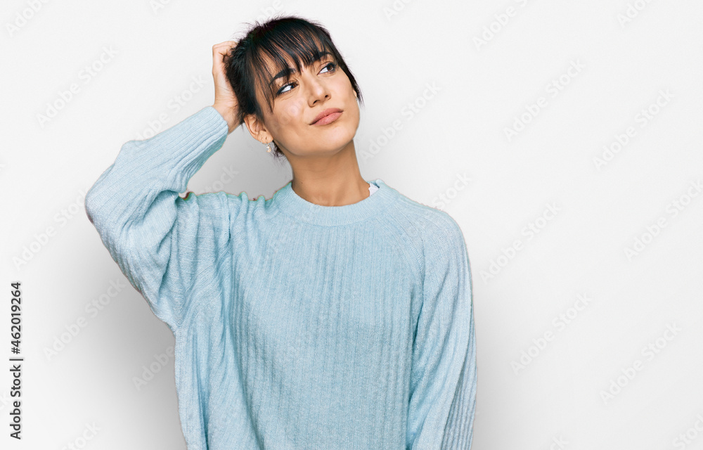 Young hispanic woman wearing casual clothes confuse and wondering about question. uncertain with doubt, thinking with hand on head. pensive concept. Young hispanic woman wearing casual clothes confuse and wondering about question. uncertain with doubt, thinking with hand on head. pensive concept.