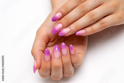Ombre on the nails. French lilac manicure on long oval nails on a white background close-up.	