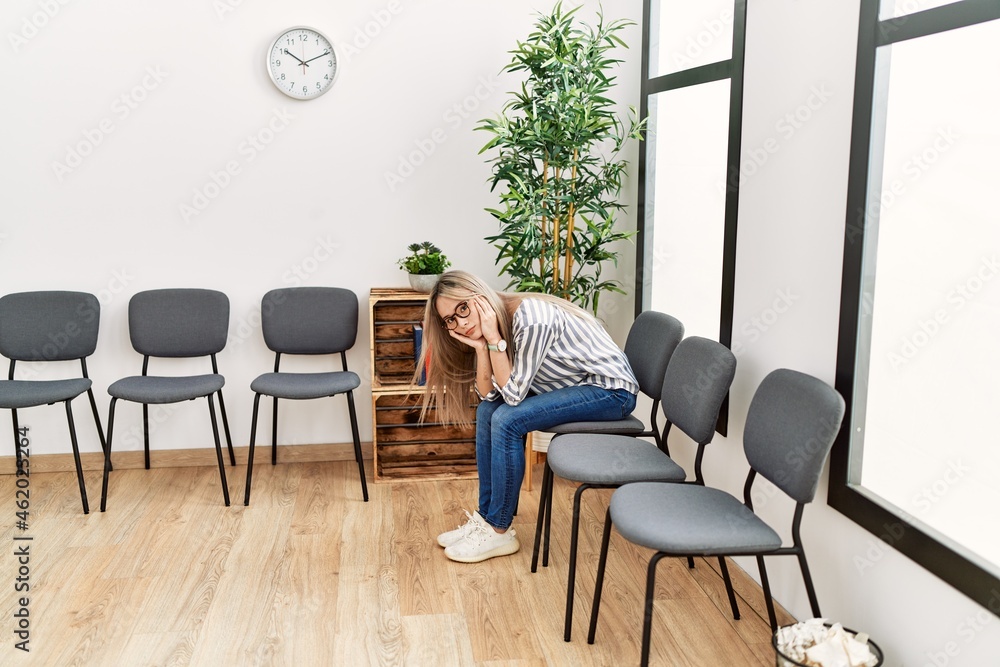 Young chinese woman desperate sitting on chair at waiting room