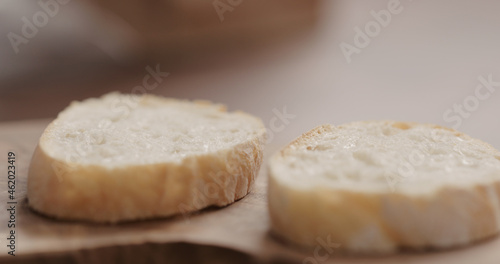 slices of rustic ciabatta on olive wood board