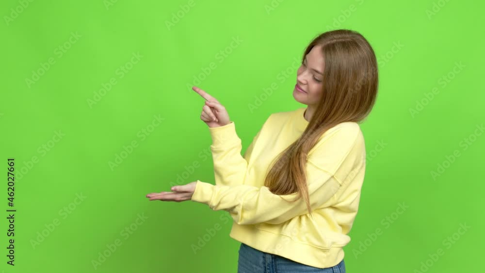 Teenager girl holding something over isolated background. Green screen chroma key Teenager girl holding something over isolated background. Green screen chroma key