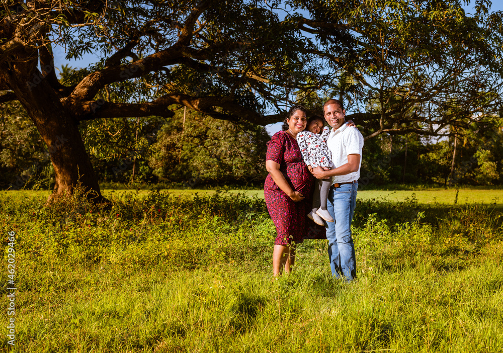 Pregnant mother, father and toddler daughter spending time outdoors. Happy maternity scene of mother father and toddler expecting a second child. Maternity photoshoot of a happy family Pregnant mother, father and toddler daughter spending time outdoors. Happy maternity scene of mother father and toddler expecting a second child. Maternity photoshoot of a happy family