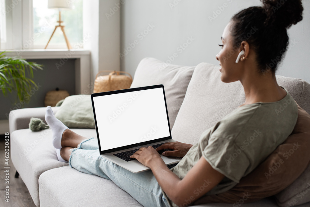 Young woman using laptop computer at home. Blank empty white screen mock up. Freelance, student lifestyle, education, web conference, video call, technology and online shopping concept Young woman using laptop computer at home. Blank empty white screen mock up. Freelance, student lifestyle, education, web conference, video call, technology and online shopping concept