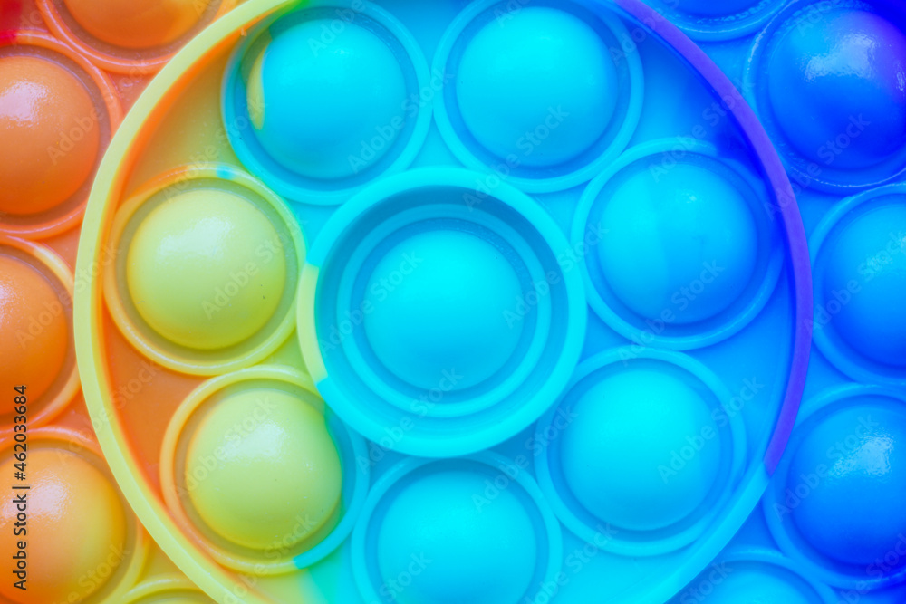 Pop it fidget. Colorful toy push pop it. Close up of anti stress sensory fidget. Trendy popular silicone colorful anti stress pop it toy .
Pop it fidget. Colorful toy push pop it. Close up of anti stress sensory fidget. Trendy popular silicone colorful anti stress pop it toy .