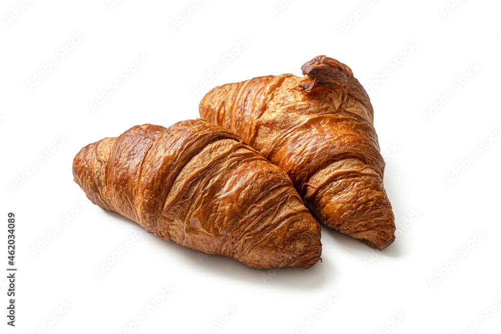 Two French croissants with a golden brown crust, on white Two French croissants with a golden brown crust, on white