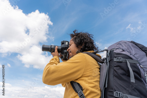 Travel photographer man taking nature photo of mountain landscape