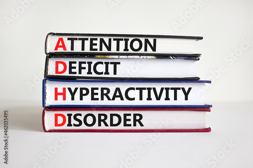 ADHD, Attention Deficit Hyperactivity Disorder symbol. Concept words 'ADHD, Attention Deficit Hyperactivity Disorder' on books on a beautiful white background. Medical, ADHD concept. Copy space.