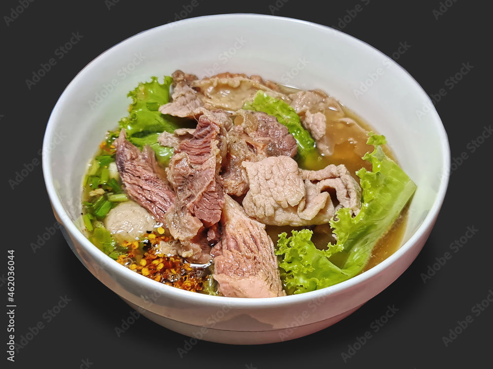 A Bowl of Spicy Soup with Beef and Meatballs Isolated on Gray A Bowl of Spicy Soup with Beef and Meatballs Isolated on Gray