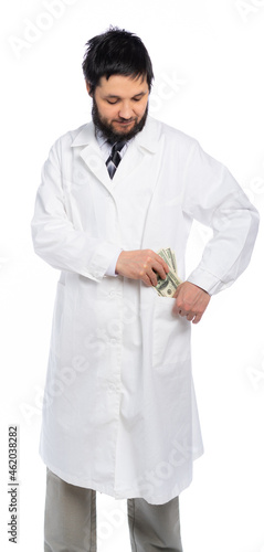 a doctor in a white coat holds bills, dollars and puts them in his pocket. isolated white background