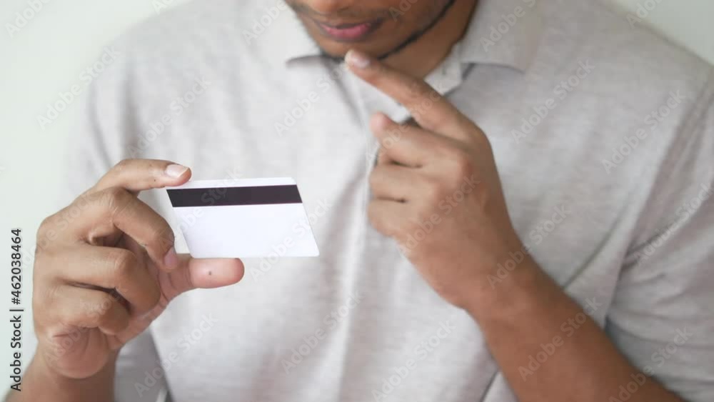 thoughtful young man hand hold a credit card thoughtful young man hand hold a credit card
