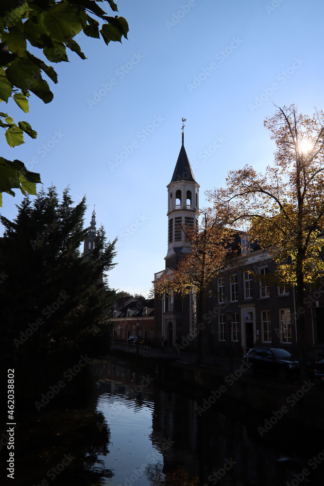 Beautiful street view of Amersfoort, the Netherlands, Classic Dutch architecture, canal, water reflections, colorful trees. Fall season in European city. 