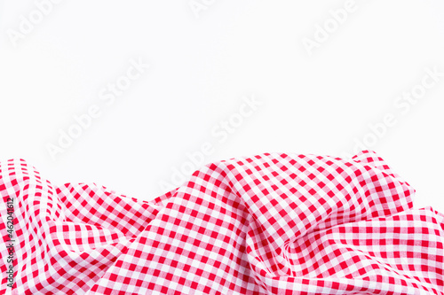Red and white tablecloth texture picnic isolated on white background. Checkers fabric crumpled top view with copy space.