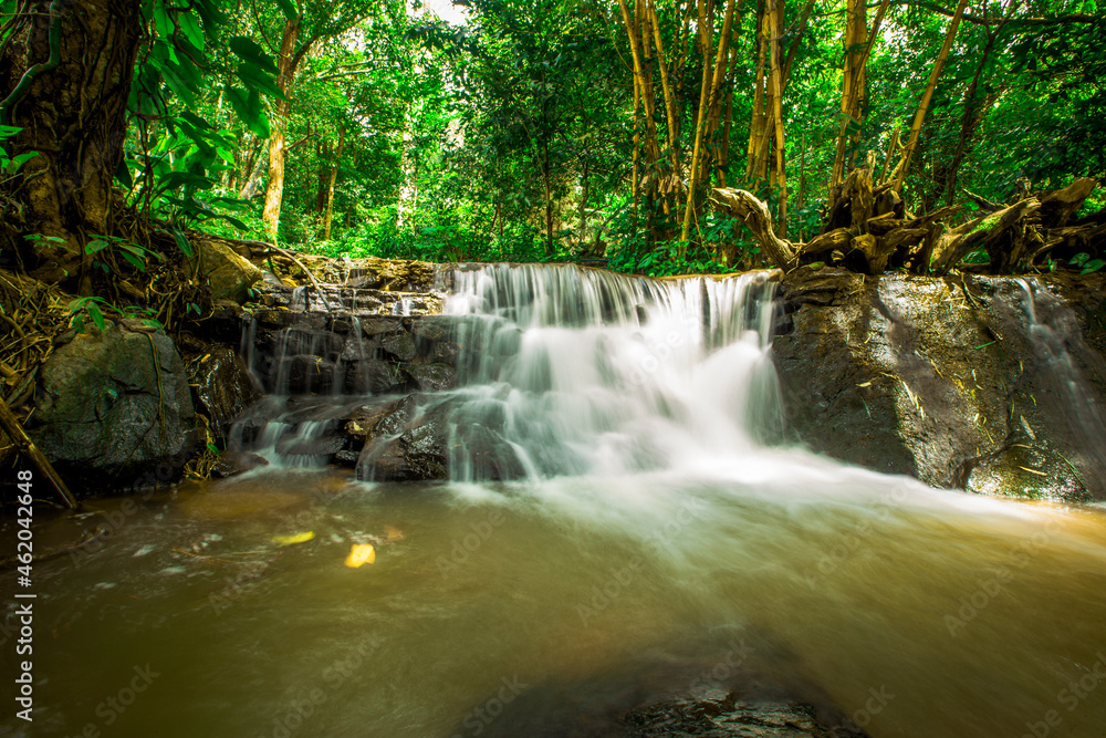 The natural background of waterfalls that blur the flow of water, with various tree species surrounded and boulders of various sizes, the beauty of the ecosystem and the jungles of forests. The natural background of waterfalls that blur the flow of water, with various tree species surrounded and boulders of various sizes, the beauty of the ecosystem and the jungles of forests.